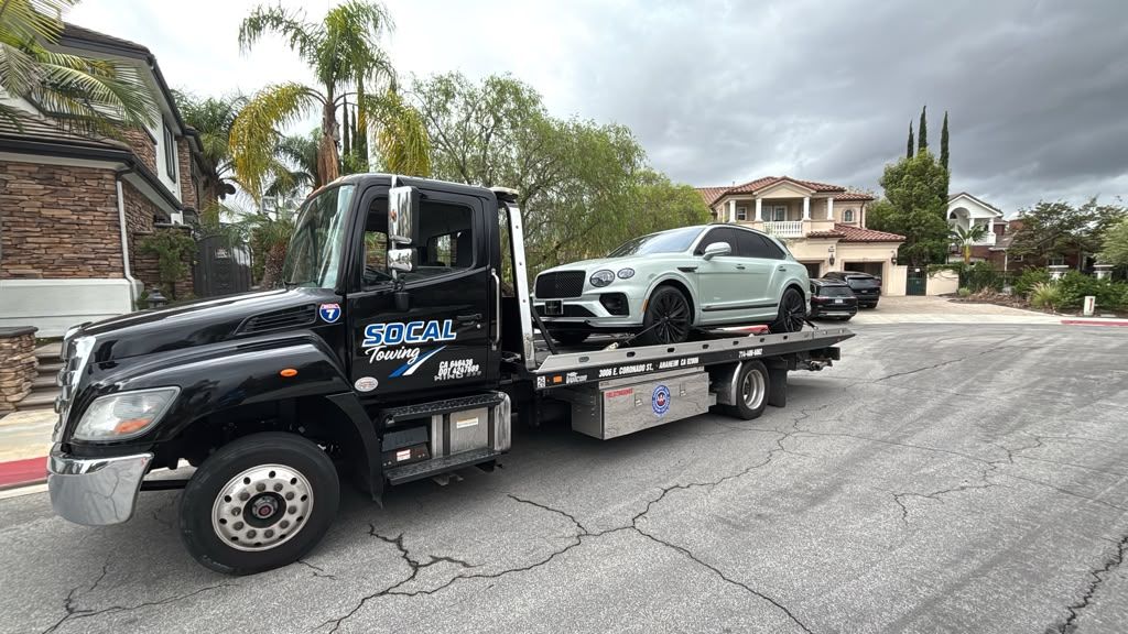 Bentley Bentayga on a SoCal Towing flatbed in a residential neighborhood